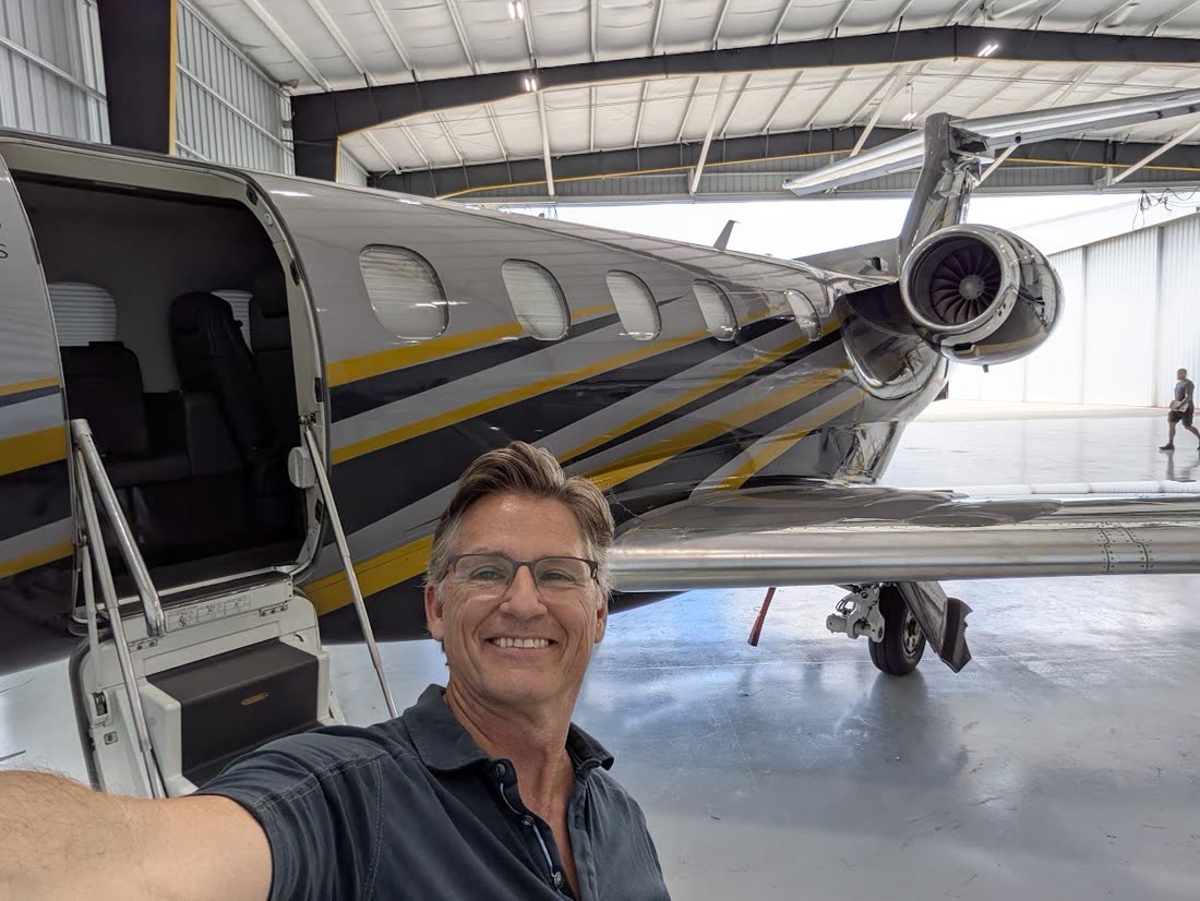 Russell with the Embraer Phenom 300 in the hangar