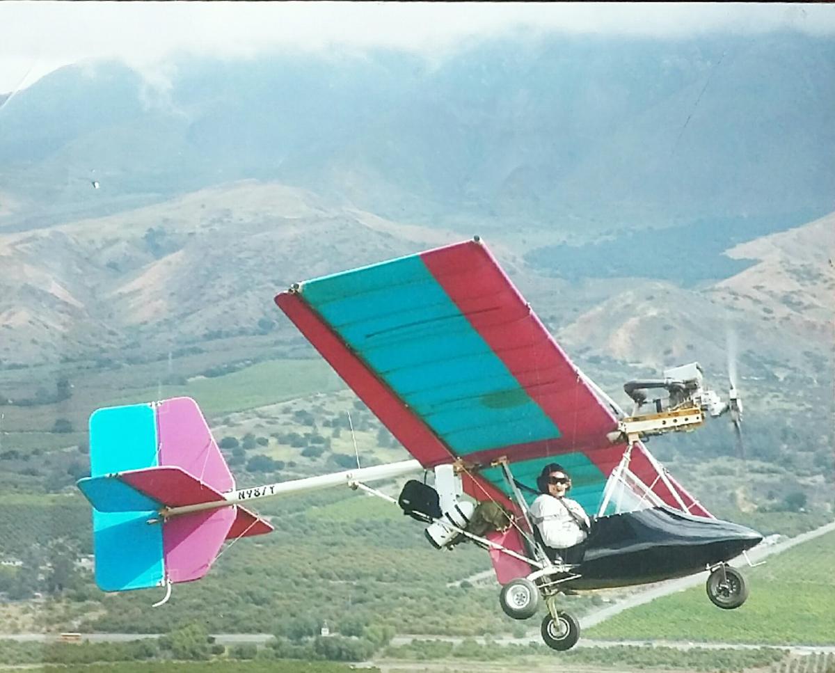 Russell flying his ultralight past the mountains