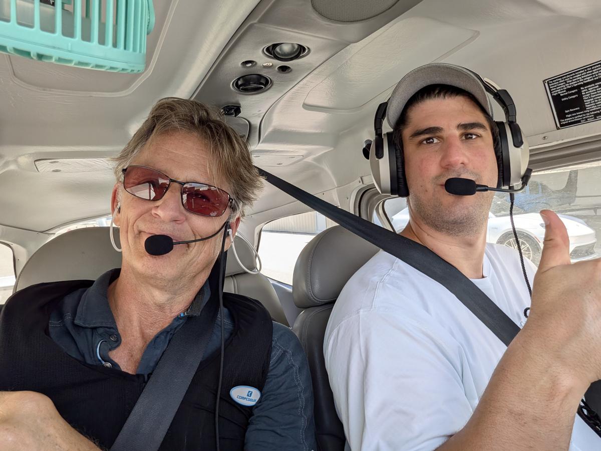 Russell in the cockpit with a student