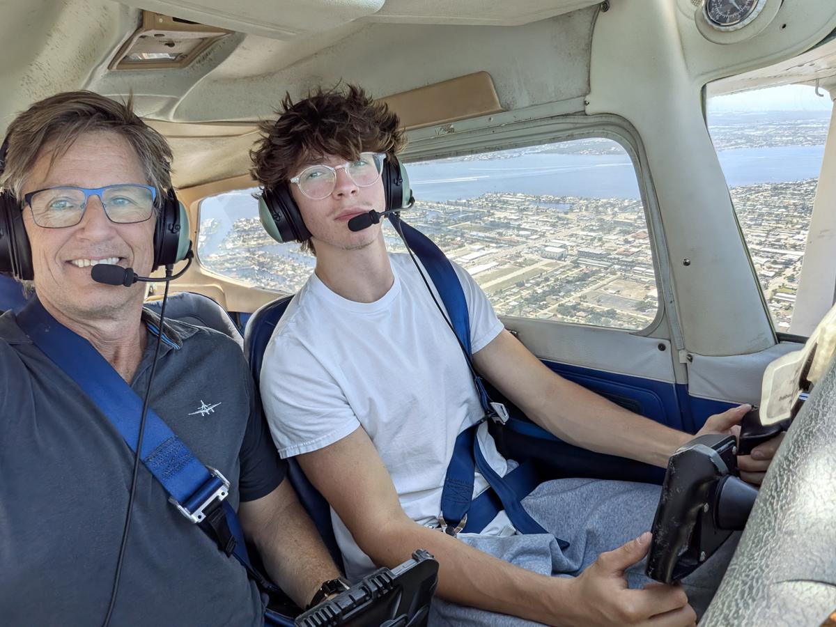 Russell in the cockpit with a student