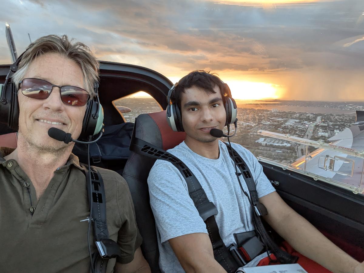 Russell in the cockpit with a student