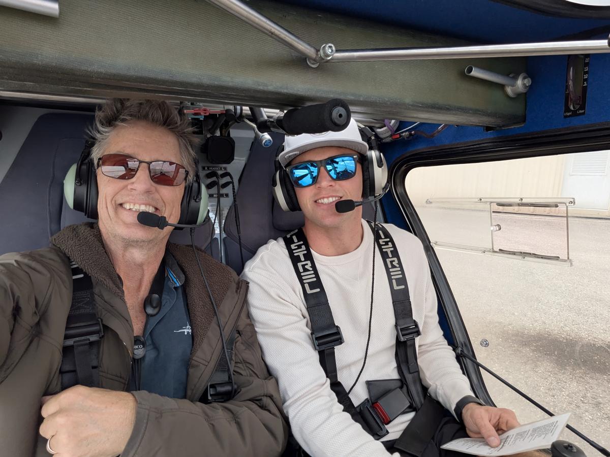 Russell in the cockpit with a student