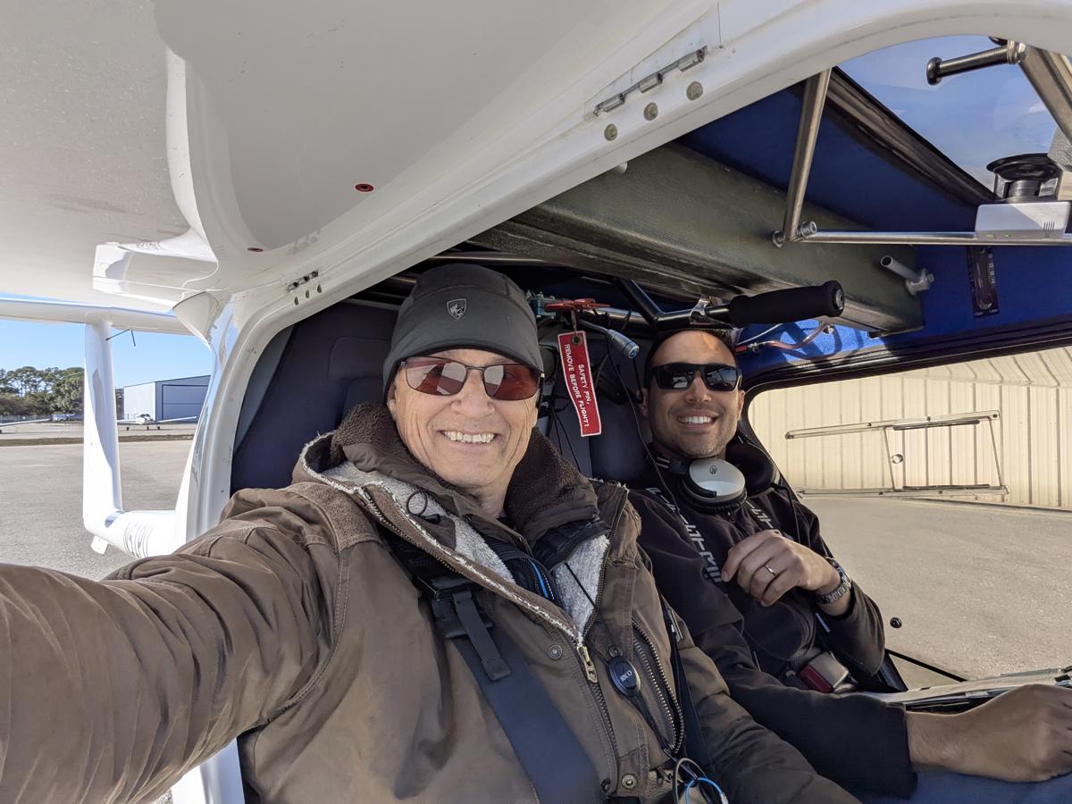 Russell in the cockpit with a student
