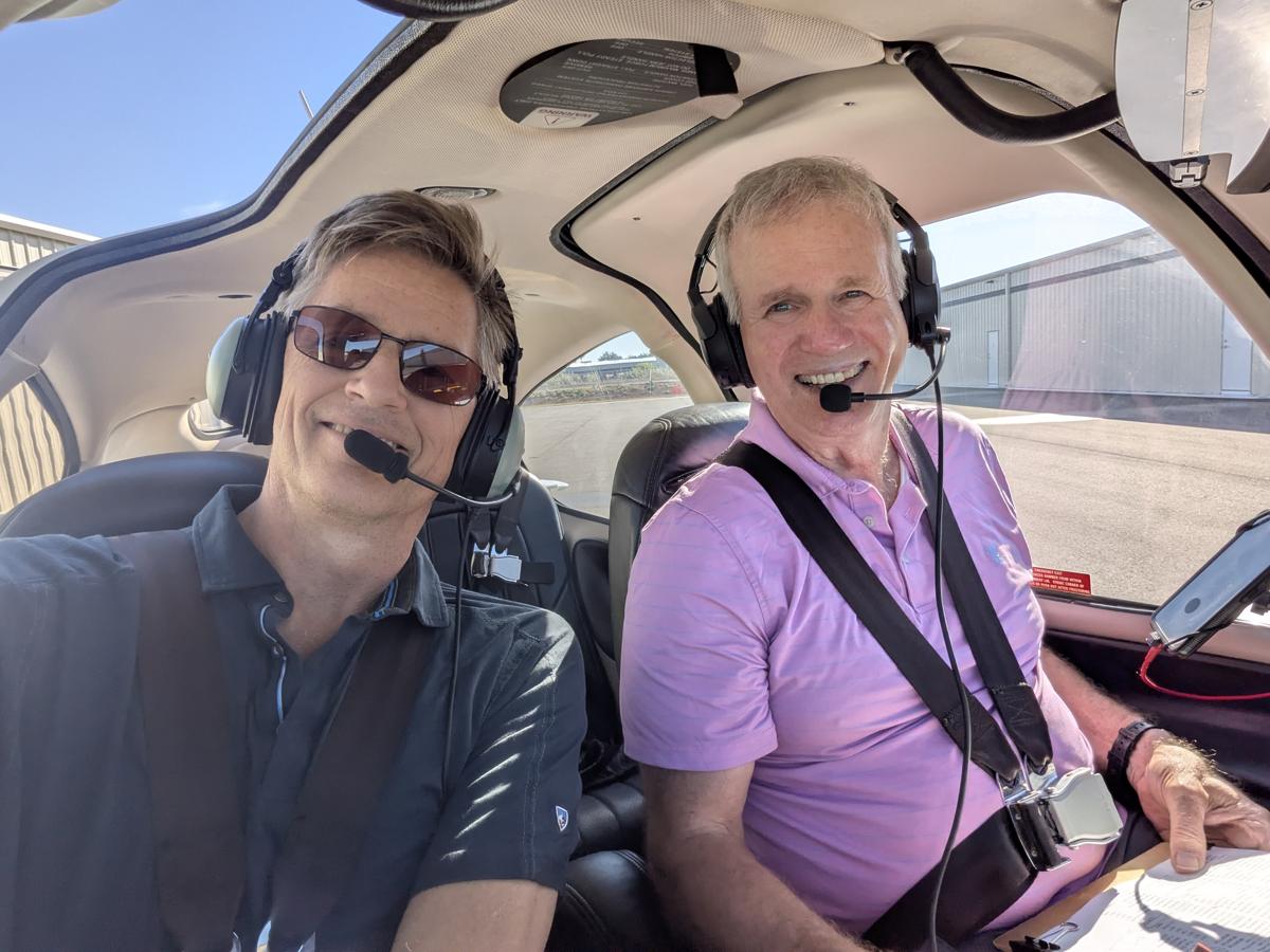 Russell in the cockpit with a student