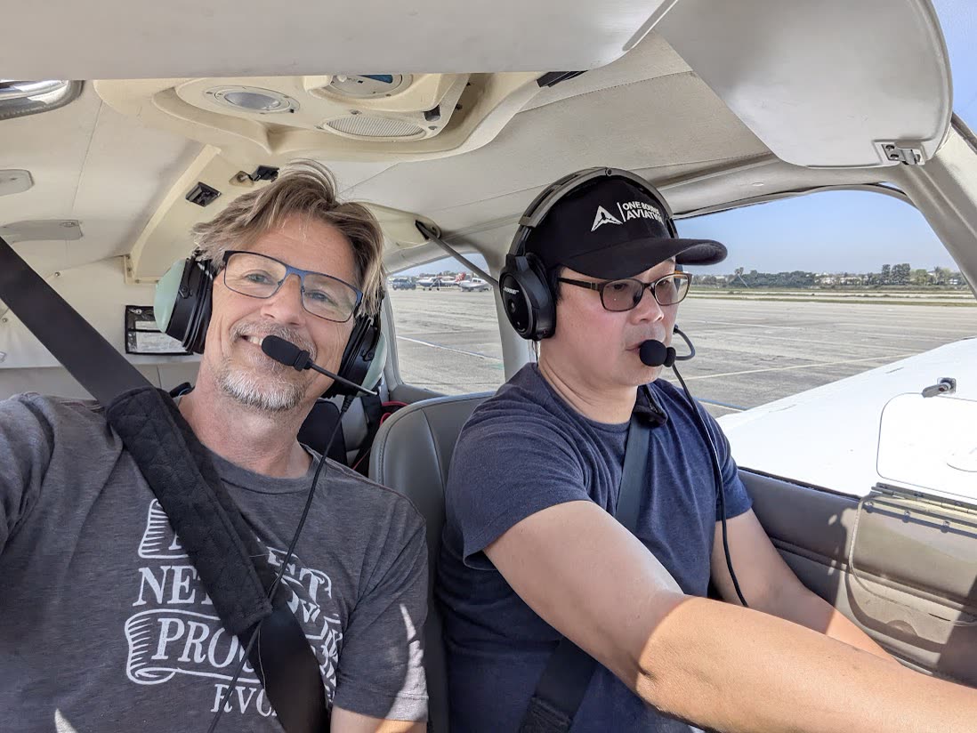 Russell in the cockpit with a student
